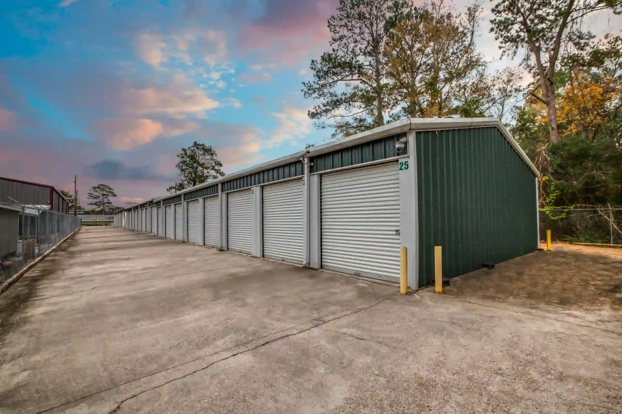 fenced storage facility with roll up doors and drive up access