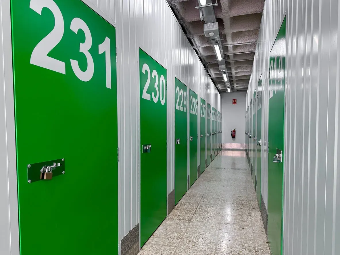 Interior hallway of climate-controlled self storage units with numbered doors.