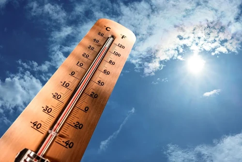 A wooden thermometer measures the temperature in Celsius and Fahrenheit to show extreme heat.