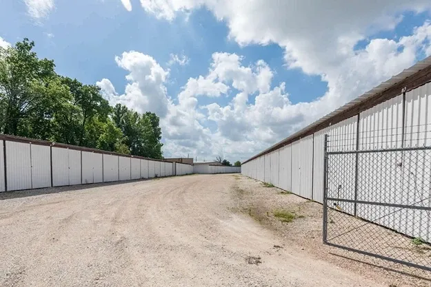 row of self storage units with drive up with a gate entry