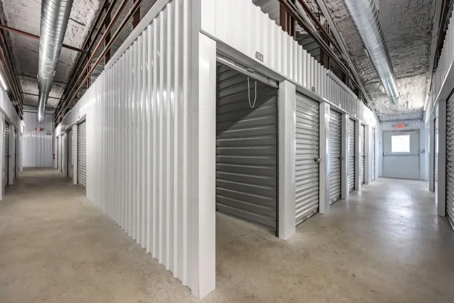 Interior self storage facility unit with the door open.