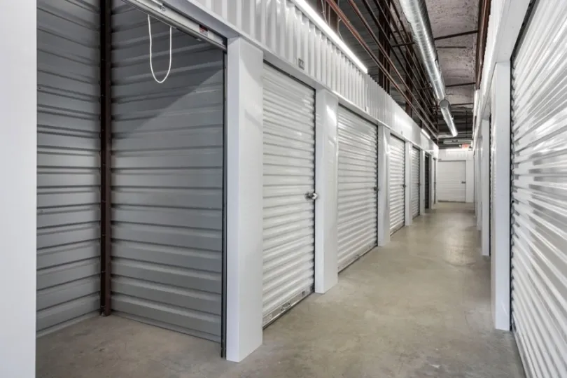 Interior self storage facility unit with the door open.