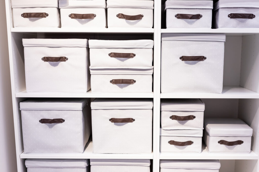 White cloth storage bins are neatly organized on shelves.